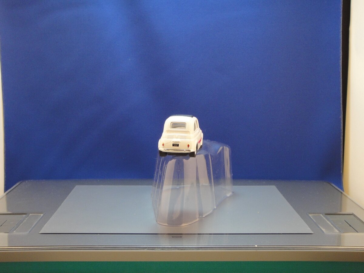 Small Fiat model photographed against a blue background for Final Freeway